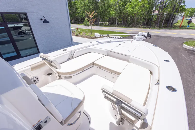 Slide: The Image of 2024 Robalo 246 Cayman boat interior with white seating and modern design. - 28