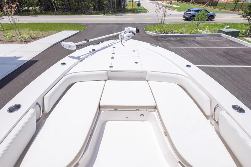 Slide: The Image of 2024 Robalo 246 Cayman boat with spacious seating and sleek design in a parking area. - 30