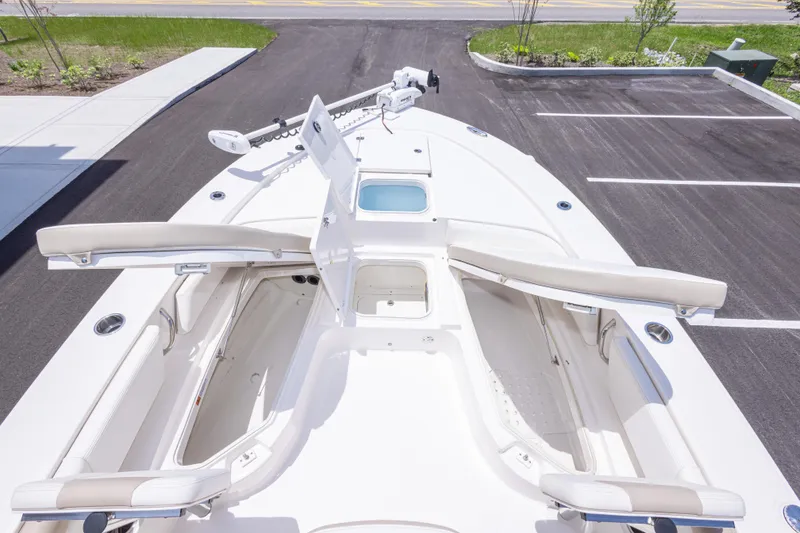 Slide: The Image of 2024 Robalo 246 Cayman boat deck with open storage compartments and seating. - 34