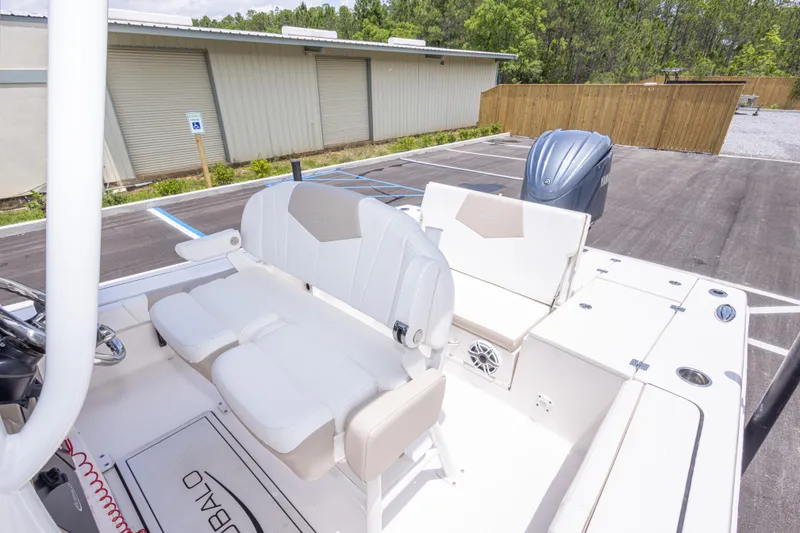 Slide: The Image of 2024 Robalo 246 Cayman boat interior with seating and engine in a parking lot. - 39