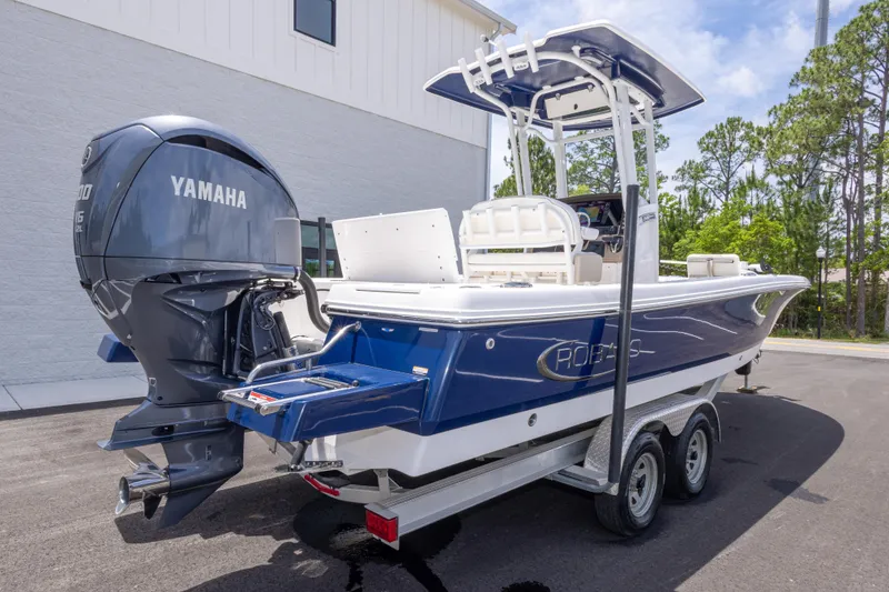 Slide: The Image of 2024 Robalo 246 Cayman boat with Yamaha engine, parked on a trailer. - 4