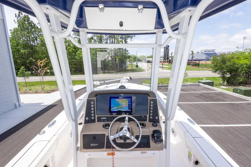 Slide: The Image of 2024 Robalo 246 Cayman boat dashboard with navigation screen and steering wheel. - 40