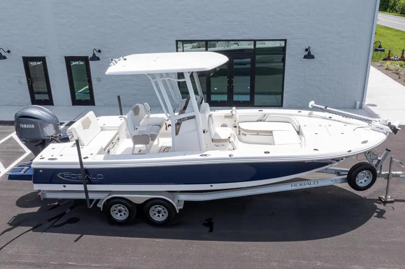 Slide: The Image of 2024 Robalo 246 Cayman boat on trailer, parked outside a building. - 44