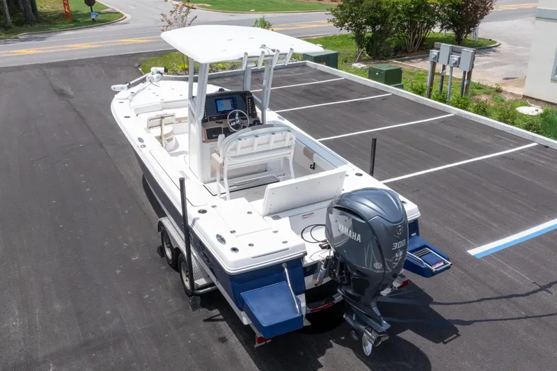 Slide: The Image of 2024 Robalo 246 Cayman boat with Yamaha 300 engine on trailer in parking lot. - 47