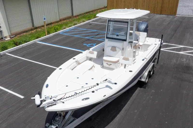 Slide: The Image of 2024 Robalo 246 Cayman boat on trailer in parking lot, side view. - 48