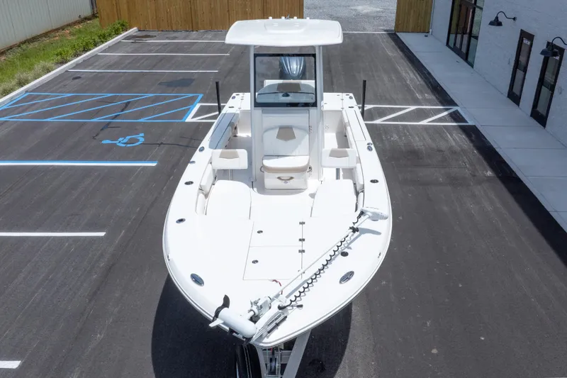 Slide: The Image of 2024 Robalo 246 Cayman boat parked in a lot, showcasing sleek design and spacious deck. - 49