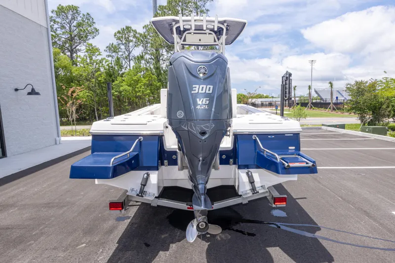 Slide: The Image of 2024 Robalo 246 Cayman boat with Yamaha 300 V6 engine, parked outdoors. - 5
