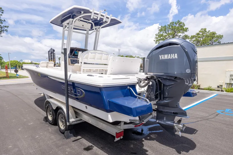Slide: The Image of 2024 Robalo 246 Cayman boat with Yamaha engine on trailer, parked outdoors. - 6