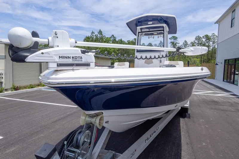 Slide: The Image of 2024 Robalo 246 Cayman boat with Minn Kota Terrova motor on trailer, parked outdoors. - 9