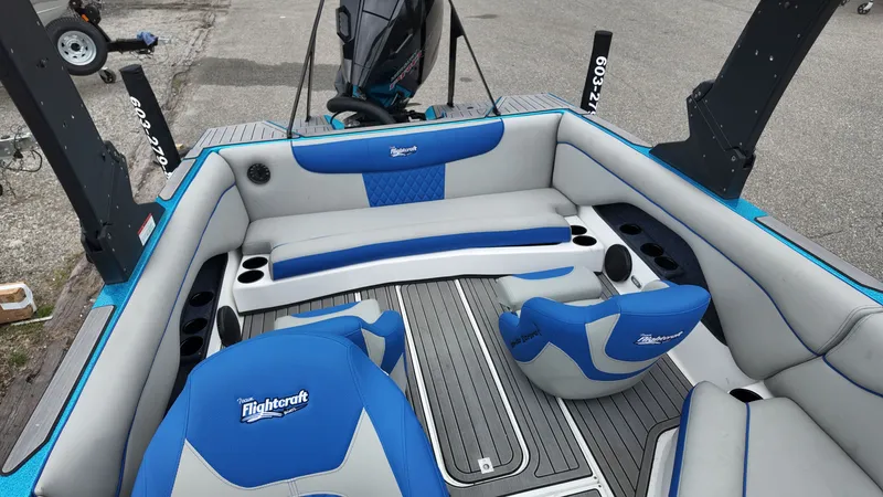 Slide: The Image of Interior of a 2025 Flightcraft boat with blue and gray seating. - 11