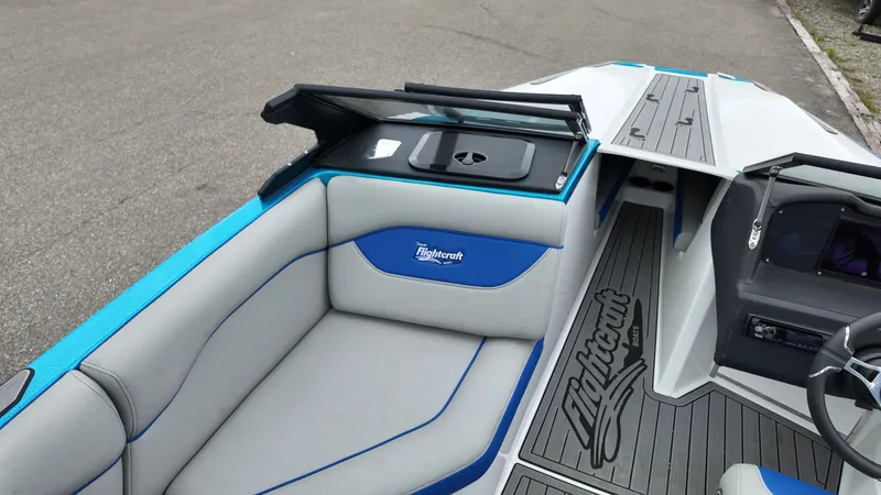 Slide: The Image of Interior of a 2025 Flightcraft boat with gray and blue seating. - 12