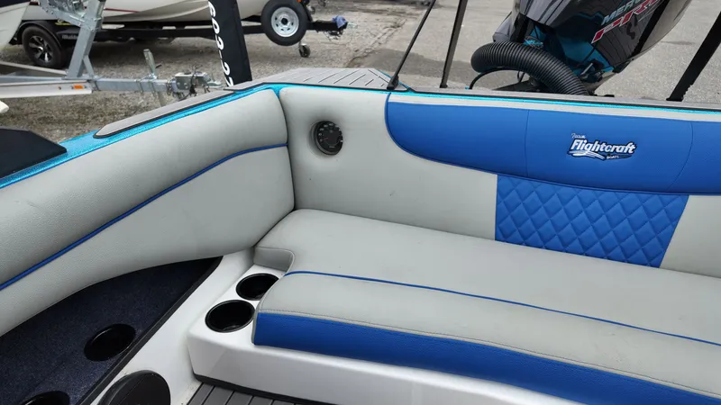 Slide: The Image of Interior of a 2025 Flightcraft boat with blue and gray seating. - 16