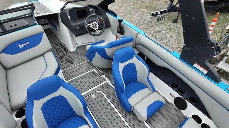 Slide: The Image of Interior of a 2025 Flightcraft boat with blue and gray seating. - 18