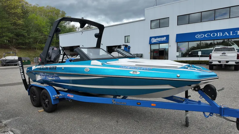Slide: The Image of 2025 Flightcraft Boats model on blue trailer in front of building. - 2
