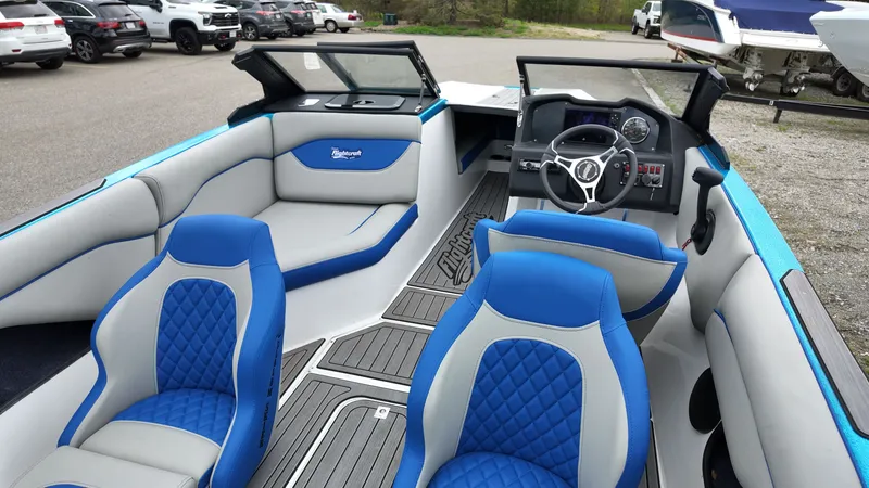 Slide: The Image of Interior of a 2025 Flightcraft boat with blue seating. - 9