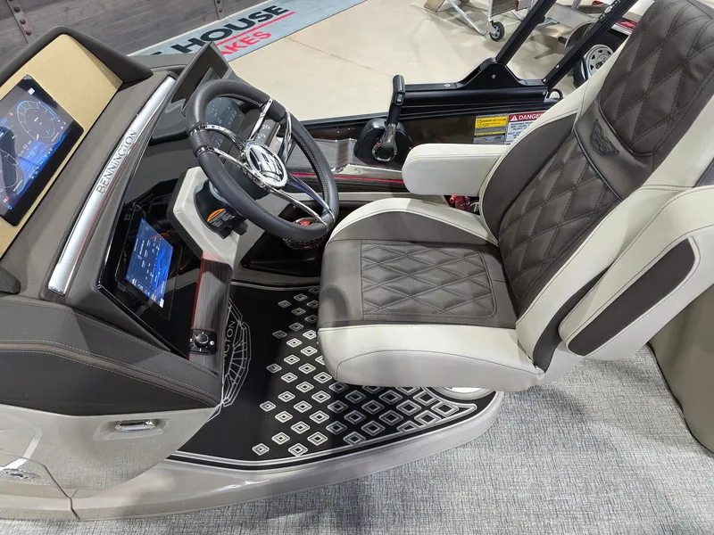 Slide: The Image of Interior of 2026 Bennington 25QFB ESP TRI PB with luxurious seat and control console. - 21