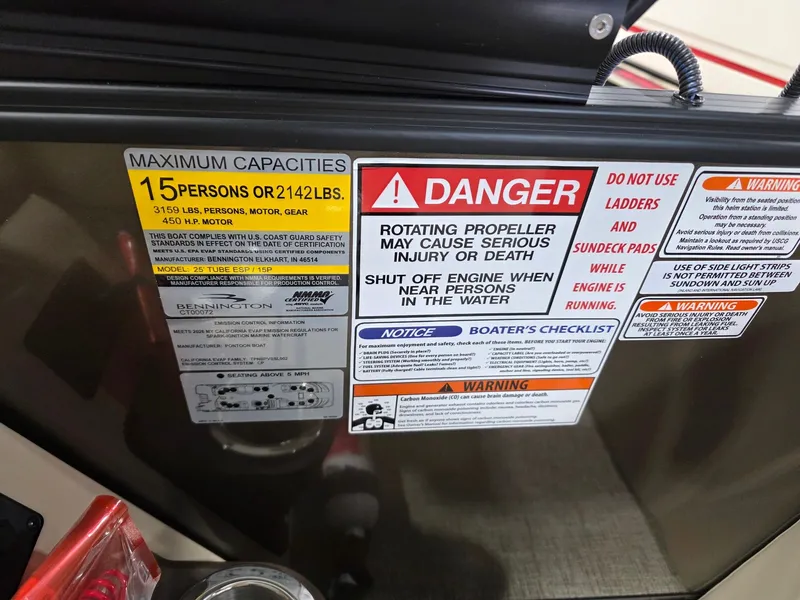 Slide: The Image of Safety and capacity warnings on a Bennington 25QFB ESP TRI PB boat. - 25