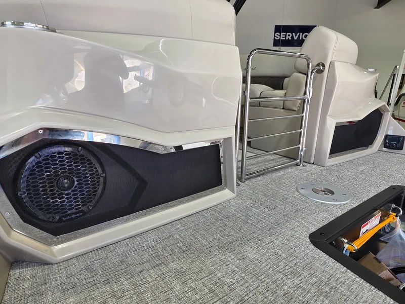 Slide: The Image of Interior of 2026 Bennington 25QFB ESP TRI PB with speaker and seating area. - 9