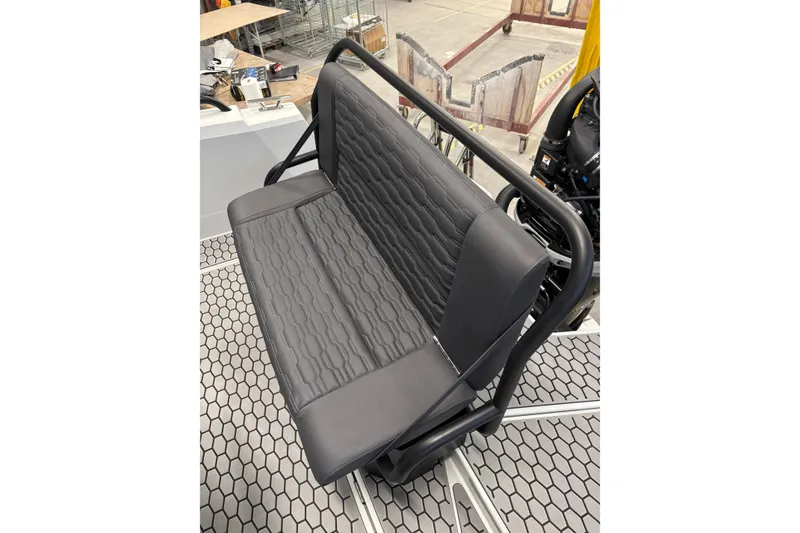 Slide: The Image of Gray bench seat on 2026 XO DFNDR 8 boat, featuring hexagonal floor pattern. - 11
