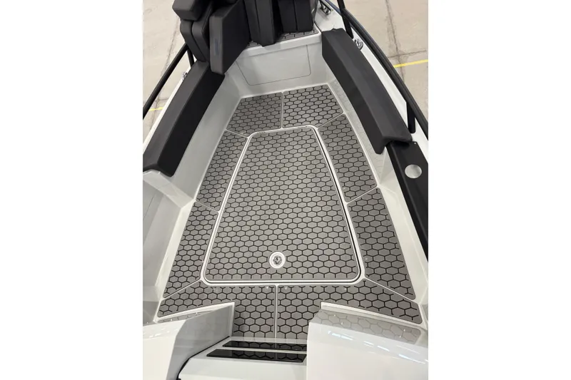 Slide: The Image of 2026 XO DFNDR 8 boat interior with hexagonal patterned flooring and cushioned seating. - 5