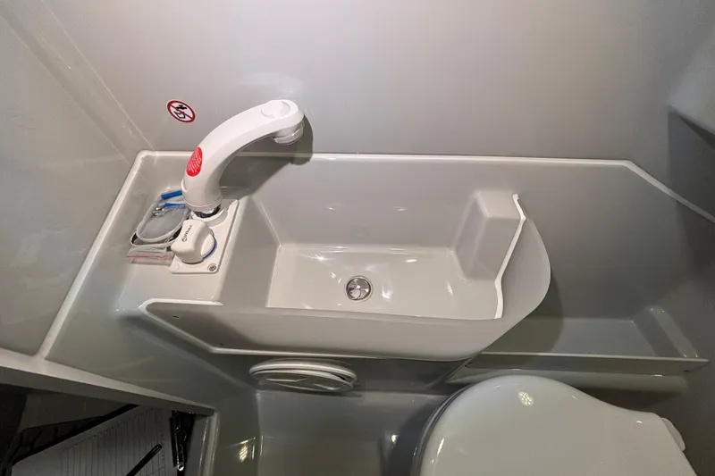 Slide: The Image of Compact bathroom sink in 2026 XO DFNDR 8 boat interior. - 7