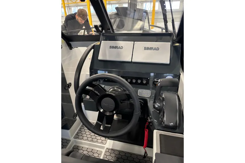 Slide: The Image of Steering console of 2026 XO DFNDR 8 boat with Simrad displays and controls. - 9
