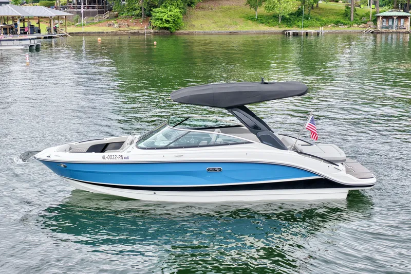 The Image of 2023 Sea Ray SLX 260 boat on a tranquil lake. - 0