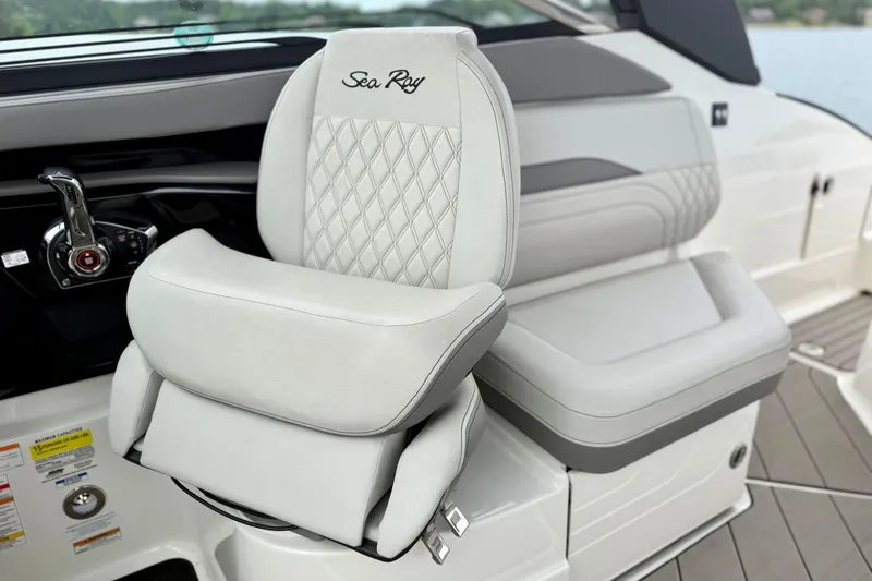 Slide: The Image of 2023 Sea Ray SLX 260 boat interior with luxurious white seating and control panel. - 12