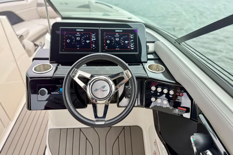 Slide: The Image of 2023 Sea Ray SLX 260 helm with modern controls and dual Simrad displays. - 14