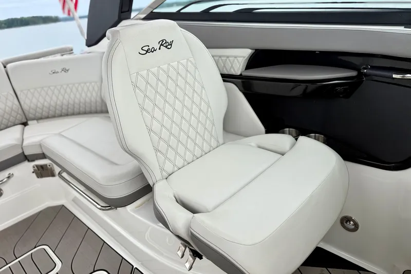 Slide: The Image of 2023 Sea Ray SLX 260 boat interior with luxurious white seating and elegant design. - 16