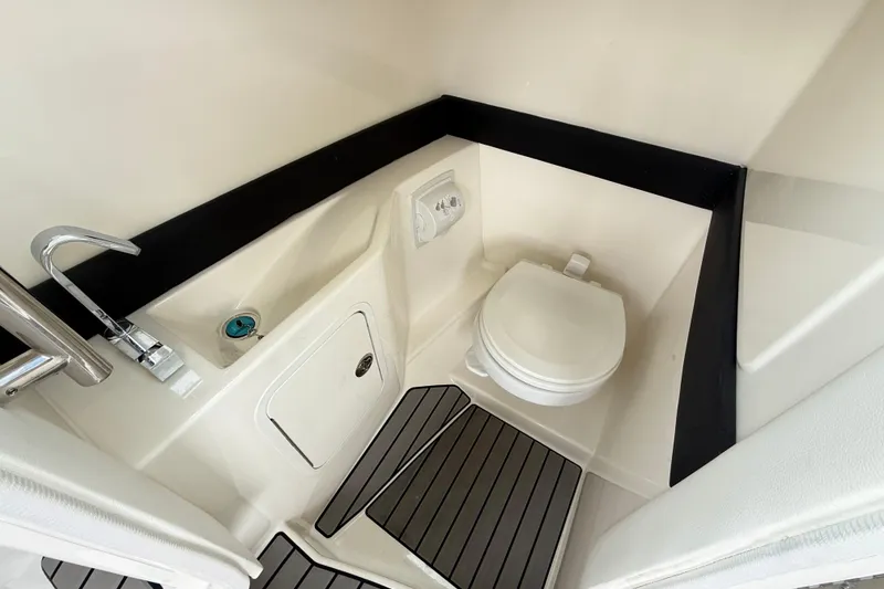Slide: The Image of 2023 Sea Ray SLX 260 boat bathroom with modern fixtures and sleek design. - 18