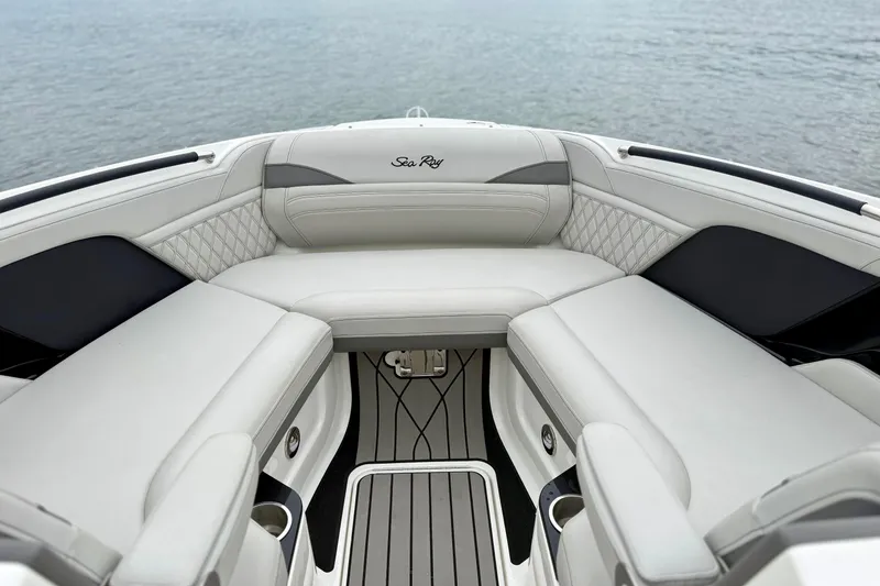 Slide: The Image of Luxurious seating area on 2023 Sea Ray SLX 260 boat, overlooking calm waters. - 19
