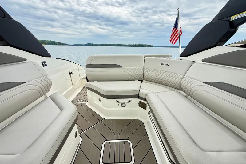 Slide: The Image of 2023 Sea Ray SLX 260 boat interior with luxurious seating and scenic lake view. - 23