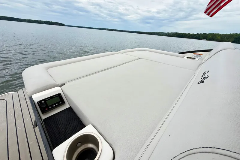 Slide: The Image of 2023 Sea Ray SLX 260 boat with spacious sunpad and lake view. - 25
