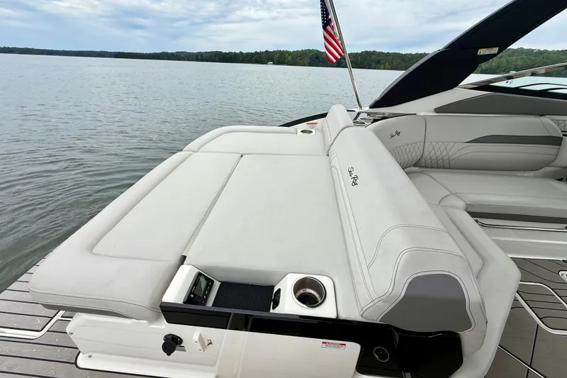 Slide: The Image of 2023 Sea Ray SLX 260 boat interior with luxurious seating and lake view. - 26