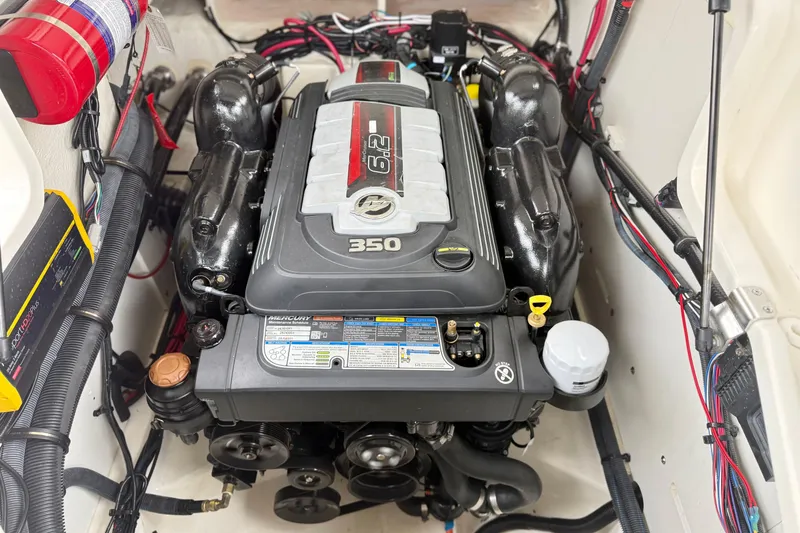 Slide: The Image of 2023 Sea Ray SLX 260 engine compartment featuring a powerful 6.2L 350 HP Mercury engine. - 27