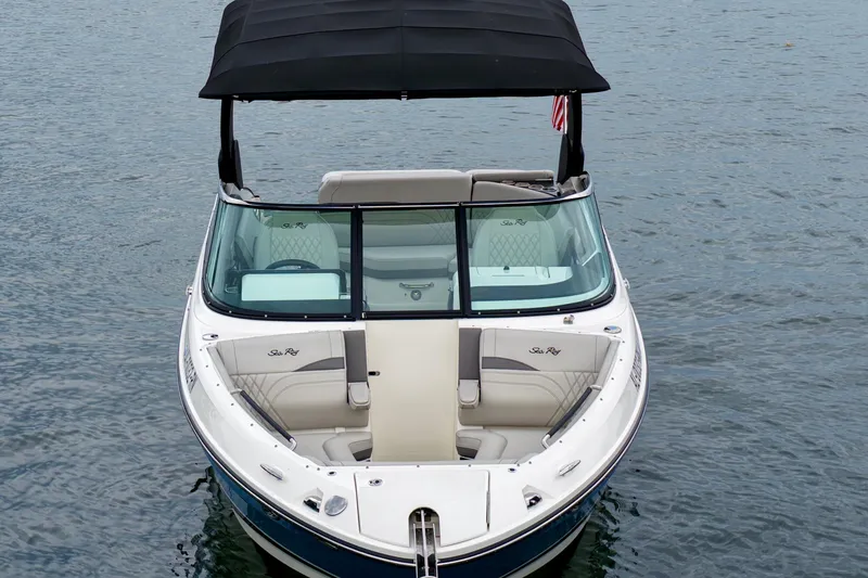 Slide: The Image of 2023 Sea Ray SLX 260 boat with black canopy on calm water. - 3