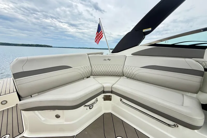 Slide: The Image of Luxurious seating on 2023 Sea Ray SLX 260 boat with American flag in background. - 9