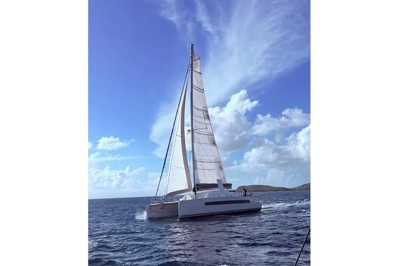 The Image of 2021 Catana 53 sailing catamaran on open sea under clear blue sky. - 1