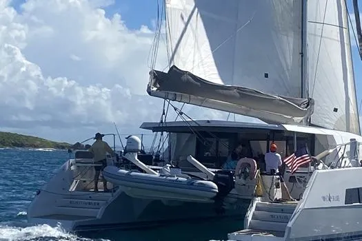 Slide: The Image of 2021 Catana 53 sailing catamaran on the water with people onboard. - 10