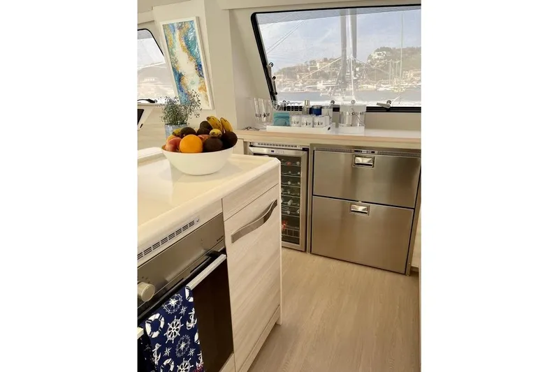 Slide: The Image of Modern kitchen interior of 2021 Catana 53 yacht with stainless steel appliances and fruit bowl. - 21
