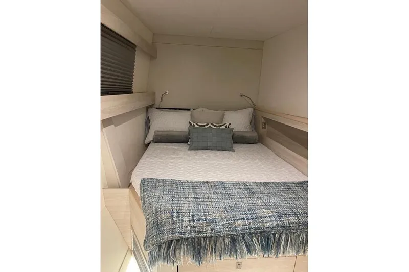 Slide: The Image of Cozy bedroom interior of 2021 Catana 53 yacht with stylish bedding and soft lighting. - 27