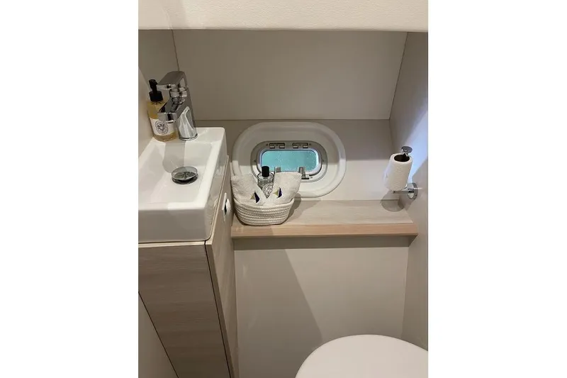 Slide: The Image of Modern bathroom in 2021 Catana 53 yacht with sink, window, and toiletries. - 31