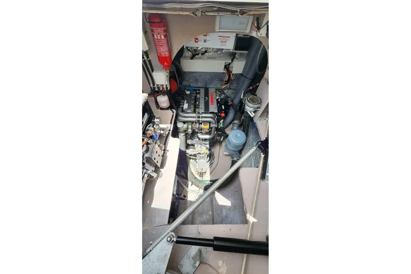 Slide: The Image of Engine room of a 2021 Catana 53 yacht, showcasing mechanical components and fire extinguisher. - 35