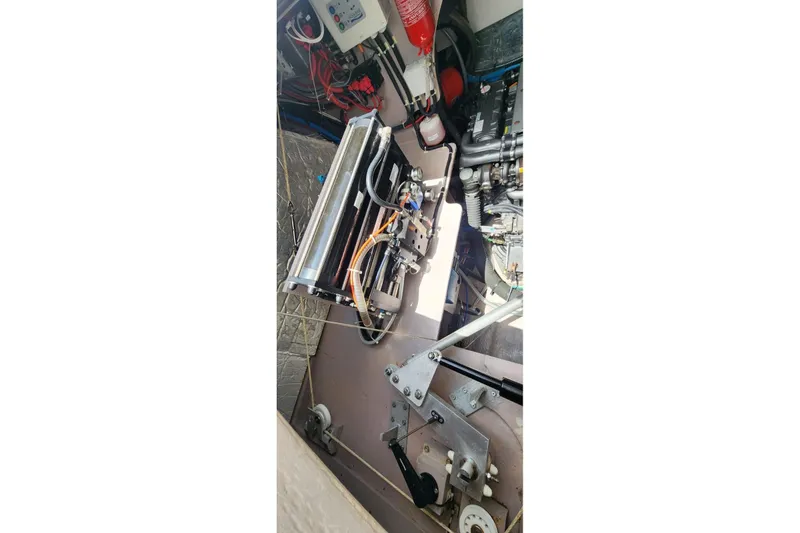 Slide: The Image of Engine room of a 2021 Catana 53 yacht, showcasing mechanical components and wiring. - 36