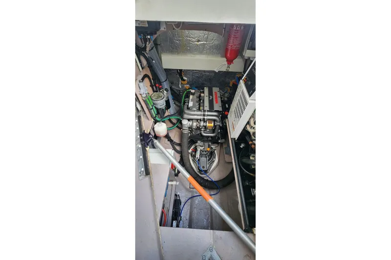 Slide: The Image of Engine room of a 2021 Catana 53 yacht, showcasing mechanical components and wiring. - 37