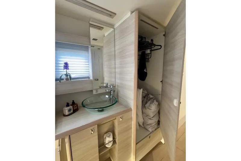 Slide: The Image of Modern bathroom on 2021 Catana 53 yacht with glass sink and storage. - 38