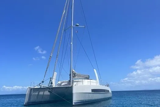 Slide: The Image of 2021 Catana 53 catamaran sailing on clear blue ocean under a bright sky. - 4