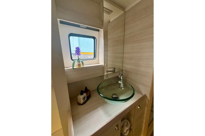 Slide: The Image of Modern bathroom in 2021 Catana 53 yacht with glass sink and window view. - 40