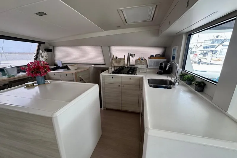 Slide: The Image of Modern kitchen interior of 2021 Catana 53 yacht with sleek countertops and floral decor. - 42